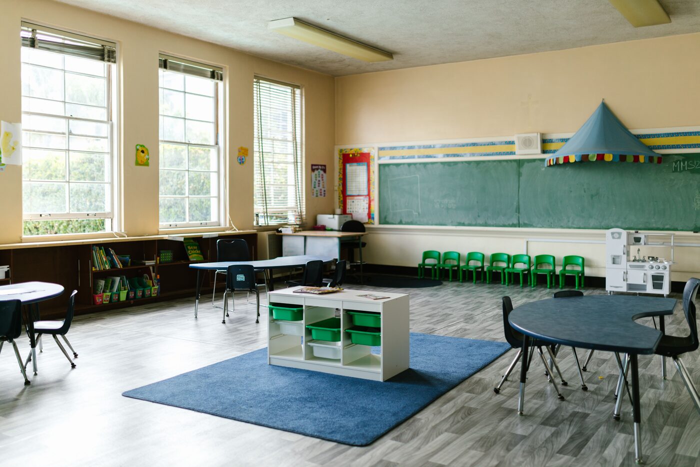 A Kidcademy teacher playing and learning with a small group of children